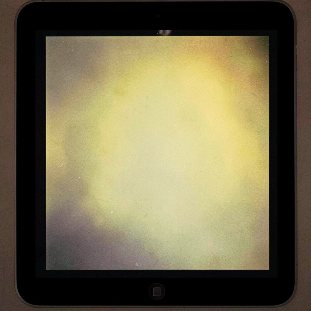Showbox app icon displayed on an iPad screen against a dark background, with rich blue and charcoal tones and visible film grain.